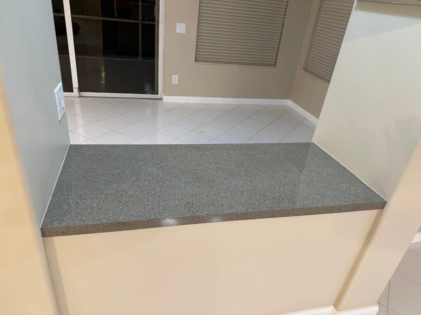 Refinished granite-look pass-through counter on a kitchen half-wall
