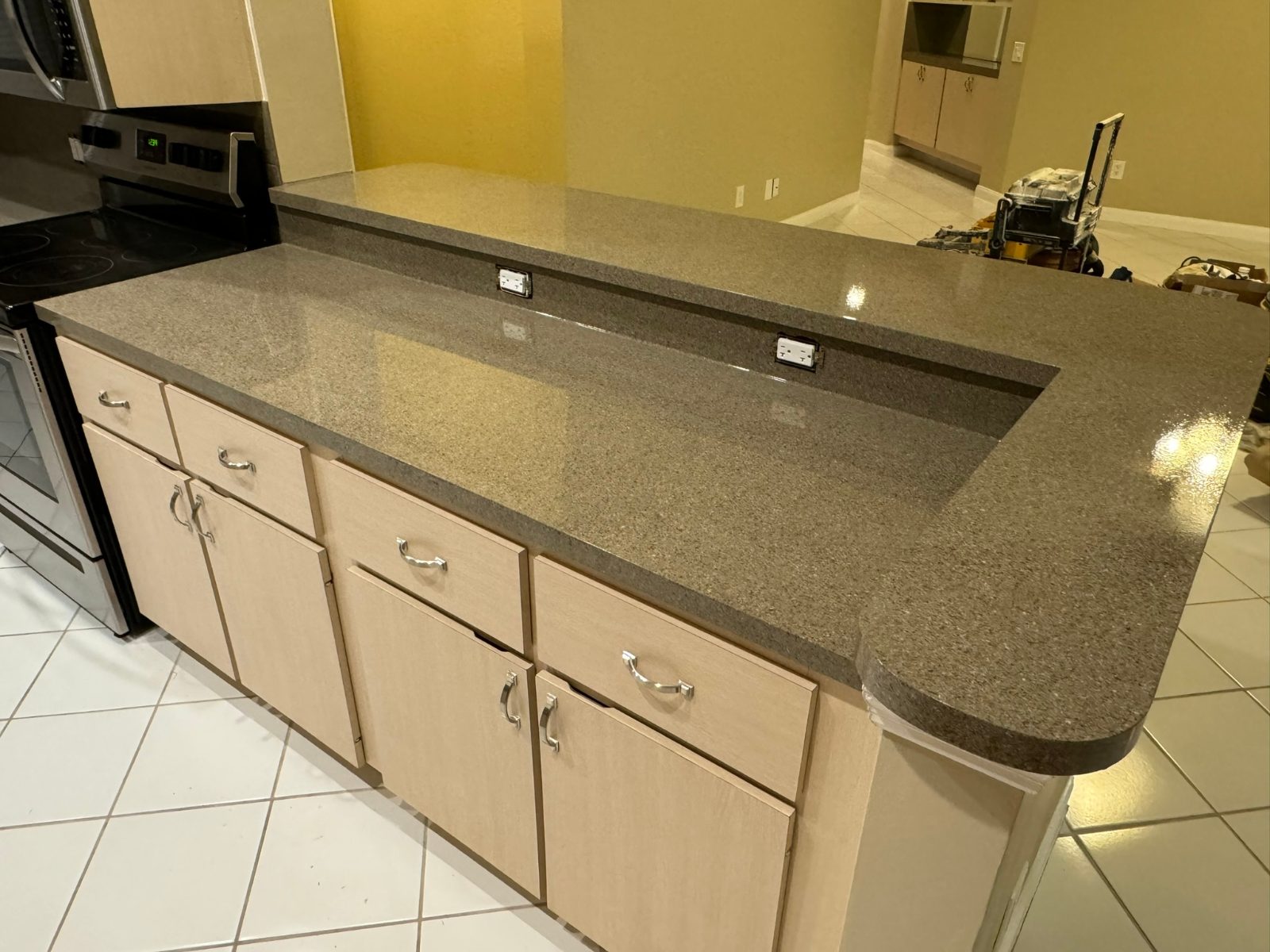 A kitchen peninsula refinished in a gray granite-look speckle finish
