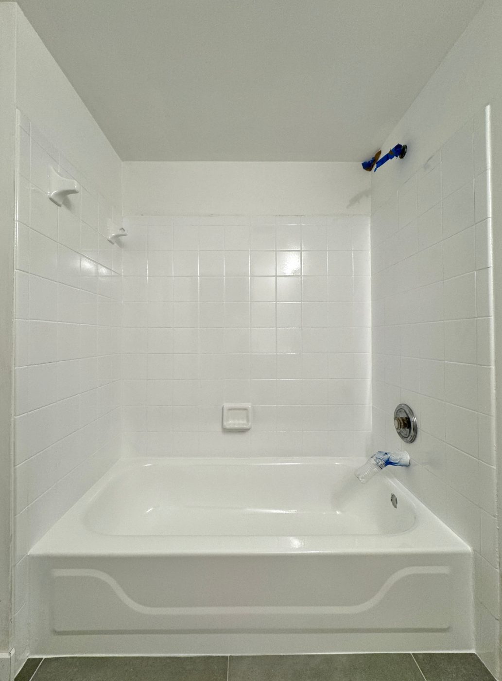 White tub and tile surround with its gloss restored, photographed straight on