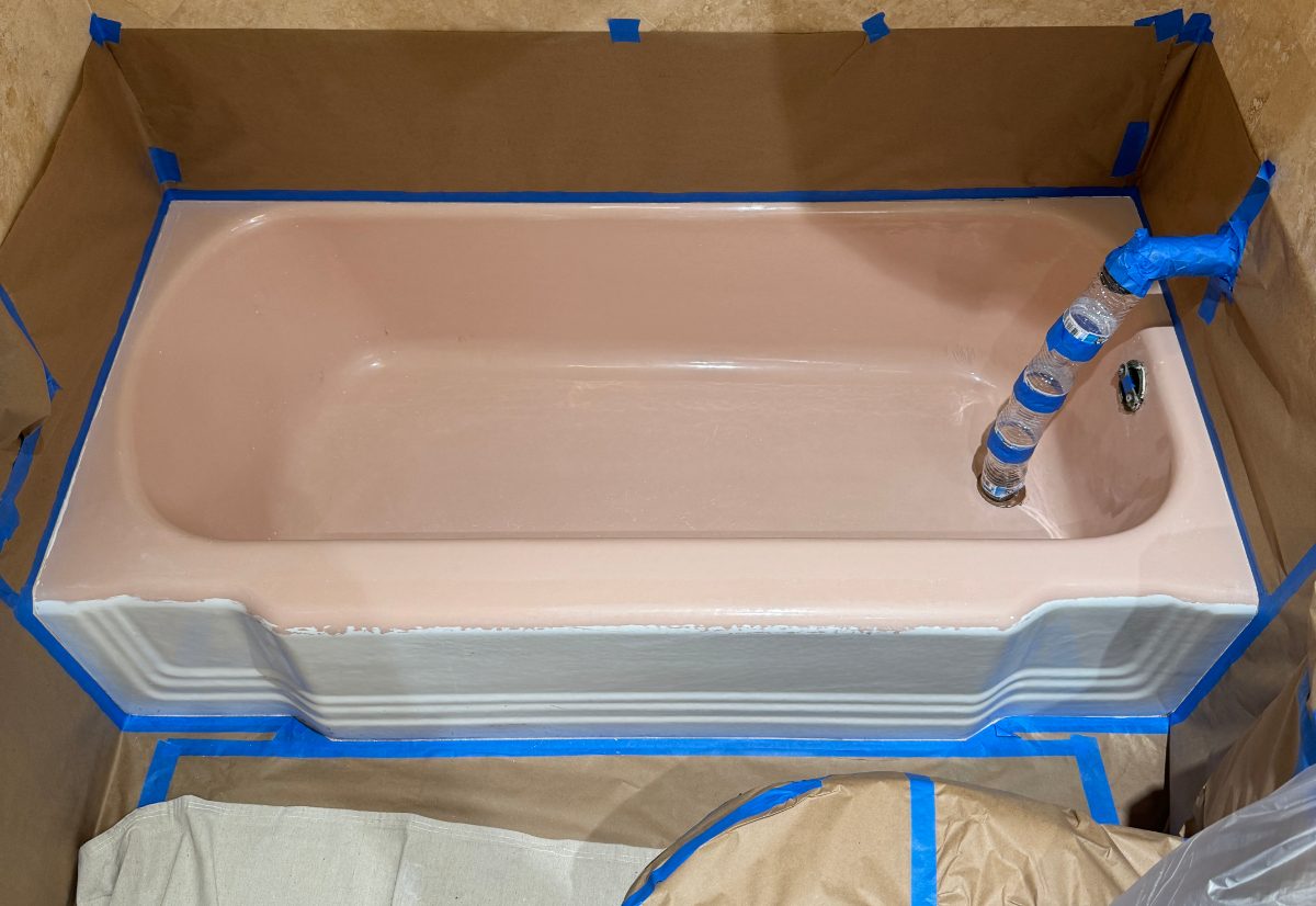 Pink tub in a travertine bath — before