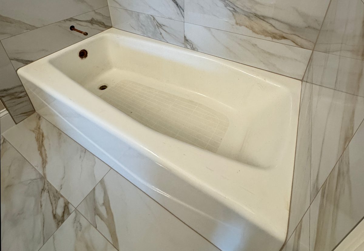 Stained white tub, restored — before
