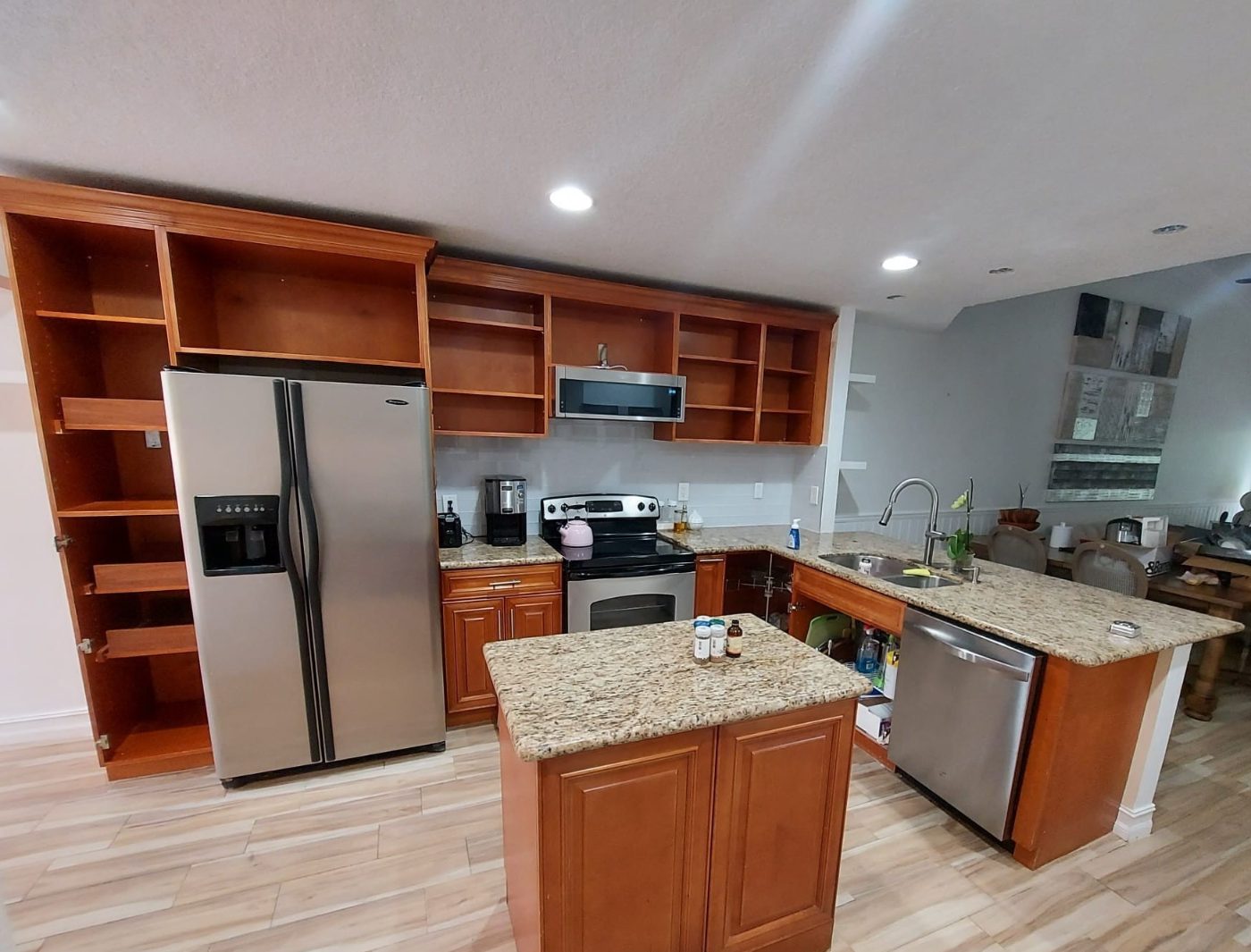The oak kitchen mid-prep — doors and drawer fronts removed, shelves emptied