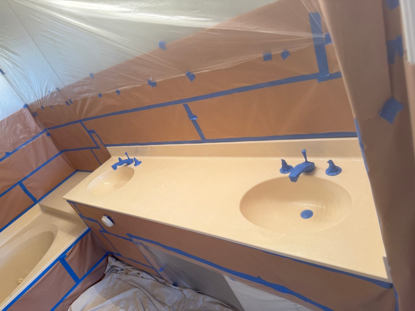 An almond double-sink vanity masked and taped off, prepped and ready to spray